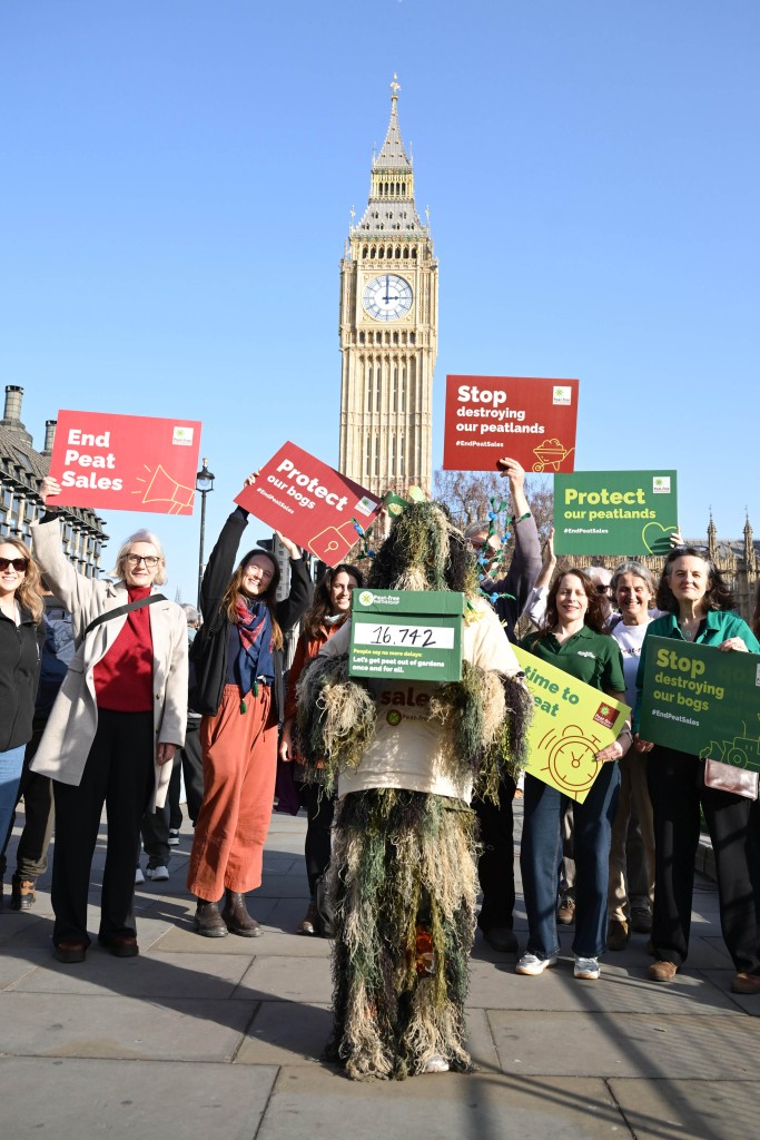 people holding placards infront of parliament
